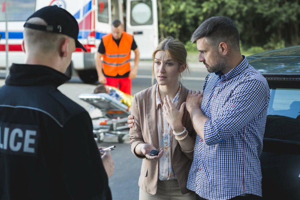 woman speaking with police after car accident